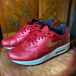 Nike Air women’s size 8.5 in metallic red with gold sequin swoosh